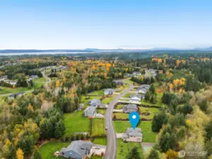 This view looks northwest towards Port Susan (Puget Sound). Notice the gorgeous Wild Ridge community. 69 homes on large lots with a meandering green belt providing privacy and pacific northwest beauty.