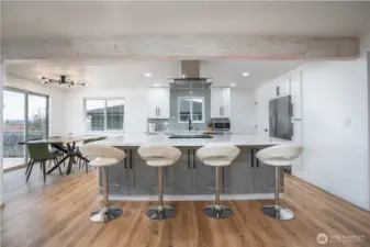 Gorgeous bright and open kitchen with huge quartz island.