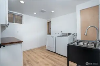 Laundry room with live edge counter tops and upper and lower cabinets for storage!