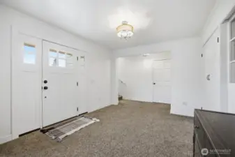 Once inside you will notice that the rooms are all large and the floorplan well thought out. The entry was once a bedroom and does have the wood floor under most of the carpet that matches that of the living room).