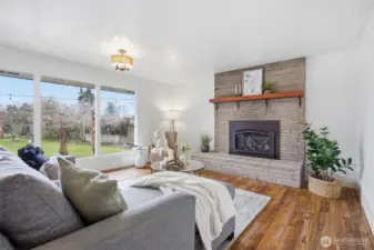 There is a gorgeous flagstone fireplace with a gas insert and an solid wood mantle, that makes for a lovely focal point in the living room.