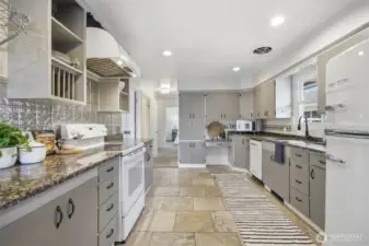 Now this is a kitchen! In keeping with the mid-century design, the updates have maintained that era! The slab granite counters are abundant, as well as the cabinet storage space and the BIG CHILL appliances (dishwasher, refrigerator and hood vent) really complete the look!