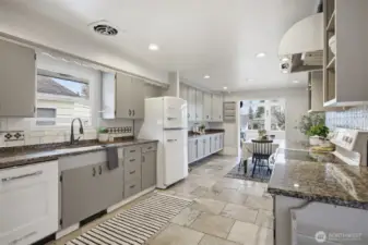 Another view of the eat-in kitchen with the spacious dining room at the far end.