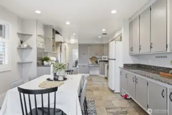 Looking at the full kitchen from the dining room, you can get a better ideal of just how spacious this are truly is. The stone tile floors really do pull everything together, too!