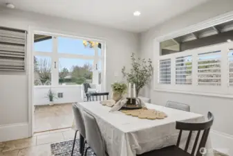The dining area is open to the incredible sunroom with so much southerly light streams in!