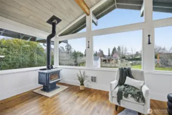 The sunroom also has hardwood floors and looks out the the flat rear yard, that is fully fenced, and has a garden area with a picket fence around it.
