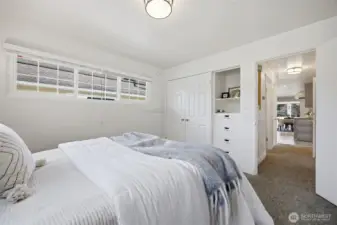 Another view of the main floor bedroom with the large closet and built-in drawers and cabinet.