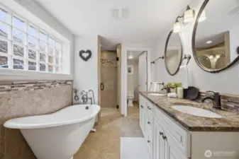 The primary bath is that that out of a spa, with the large antique-style soaking tub, the tiled walk-in shower, the large two sink vanity with the separate toilet room...all with a heated floor!