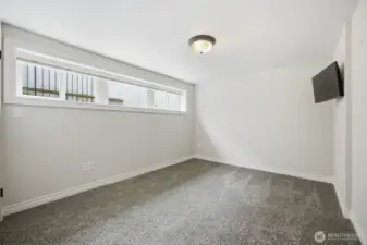 The second bedroom in the lower level is across the stairway from the primary suite and is also very generously sized.