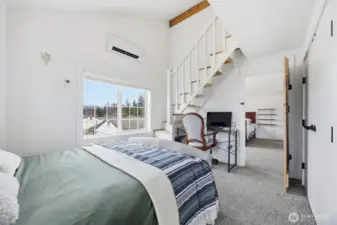 Looking across the upper north bedroom toward the stairs to the loft and the other upper bedroom with the door open between.