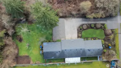 Another overhead shot showing the back portion of the 1/2 acre lot. It goes beyond the shrubs on the left.