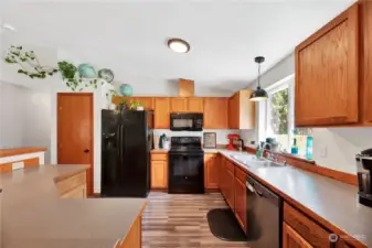The kitchen has ample counter space, bar seating area and the appliances stay and the stove in almost new.