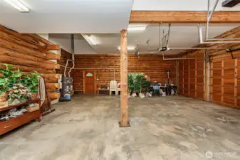 3 car garage with one 12 ft high door, storage area, central vacuum, 2 water heaters, and forced air furnace of heat pump.