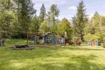 Plenty of space to play or relax on this shy acre property, including a fire pit and a partial mountain view!