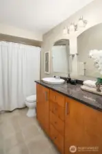 Upstairs bathroom with large soaking tub and full-size washer/dryer.