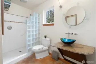 1221. Main floor bathroom features a step-in tiled shower and a granite counter with art glass sink.