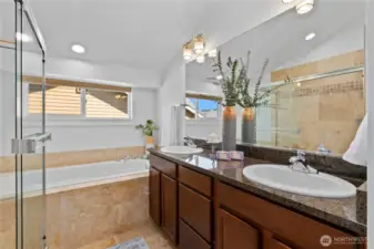 Primary bathroom with double sink, big tub, and walk-in shower.
