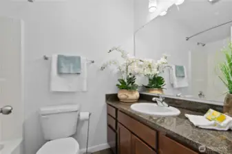 Upper floor 2nd primary full bathroom and granite countertops.
