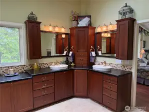 Stained cherry cabinets with two sinks and turn table in center cabinet.