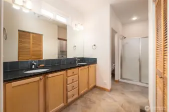 Primary bath with dual sink vanity and oversized walk-in shower with bench seating
