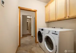 Laundry room with storage and newer front load washer and dryer