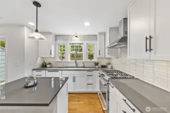Stunning kitchen renovation with custom cabinetry by Acorn Cabinets and classic Ann Stacks tile backsplash.