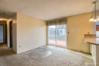 Eating space in the kitchen with sliding glass doors to the back deck