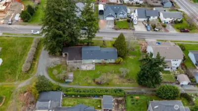 Aerial view showing the great location, alley access, garden space and fruit trees.