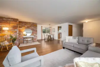 Open living, dining and entry with extra space for a desk or a piano. Freshly painted and ready for you! (staged)