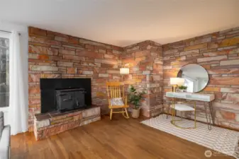 Beautiful sitting area with wood burning insert. Stunning mid-century style masonry. (staged)