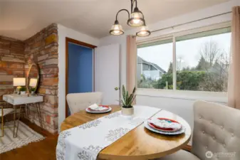 Dining area and door leading to the lower level of the home.