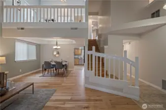 As you step inside, you get your first look at the adjacent dining area with tray ceiling, stairway w/landing, and exposed loft area flooded with natural light.