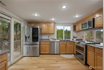 Spacious kitchen with direct deck and side yard access. Hillside bed of strawberry plants grow tons of berries right outside of the kitchen slider!
