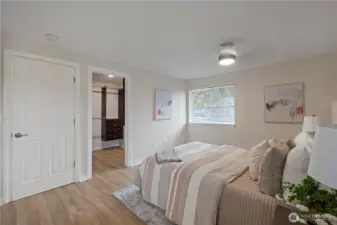 Second level primary bedroom with view of walk-in closet entry.