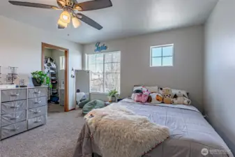 Secondary bedroom with a walkin closet