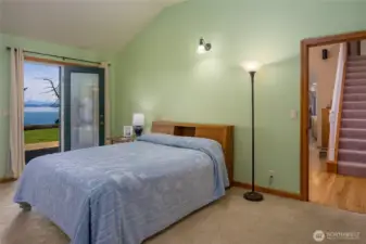 Primary bedroom with French doors to the deck.