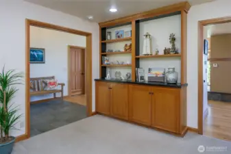 The den/office has a built-in bookcase and is between the entry and eating area.