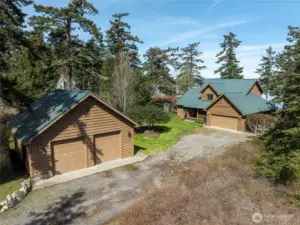 The detached shop/garage and view of the home with attached 2 car garage.