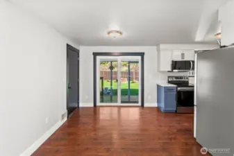 View from living room towards front door and kitchen