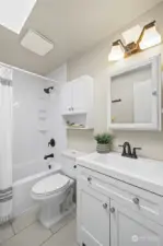 The full bathroom was recently refreshed and includes a newer bath tub surroun, toilet, vanity, tile flooring and enjoys a skylight, bringing the natural light in.