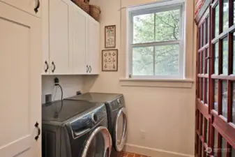 Main level laundry room (yes with a window) has plenty of storage. There is a second laundry room on the lower level.