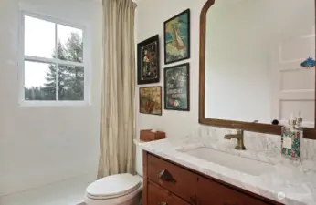 This is the main level 3/4 bathroom off of the northern entryway into your home. Lake view from the shower.