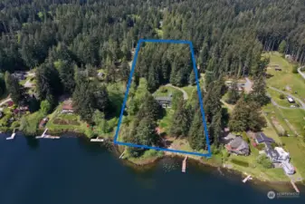 Privacy and space. With +/- 6.5 acres and +/- 326 ft of lake front, this photo reflects the rare opportunity of your own lakeside retreat. There is so much to explore here. 10ft x 40ft rebuilt dock and the new plunge dock are in view.