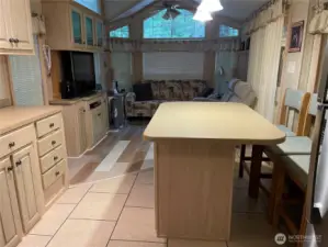 Photo from kitchen. Island in center of kitchen