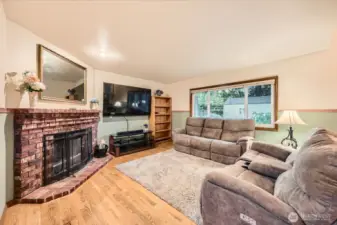 COMFORTABLE AND OPEN FAMILY ROOM W/ FIREPLACE AND VIEWS OF LUXURY BACK YARD.