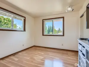 PLEASANT THIRD BEDROOM UPSTAIRS IS ENJOYABLE AND RELAXING WITH WOOD LAMINATE FLOORS.