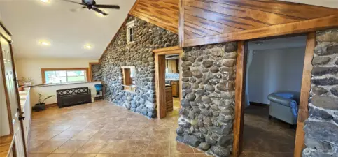 Look at that beautiful finished woodwork that compliments the rugged rock. Door on right leads to living rooms. Other door to kithcen.