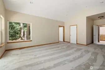 Walk in closet and entry to primary suite bath