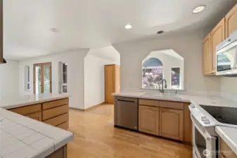 Open kitchen with so much counter space and hall pantry