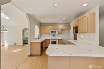 Open kitchen with so much counter space and hall pantry